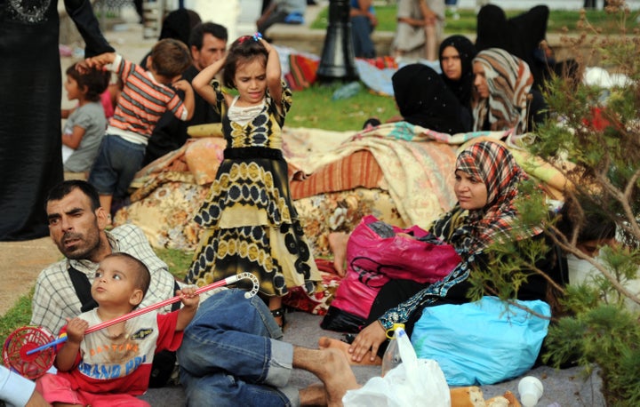 Syrians fleeing the conflict in their home country gather in a garden in Port Said Square in Algiers on July 28, 2012.