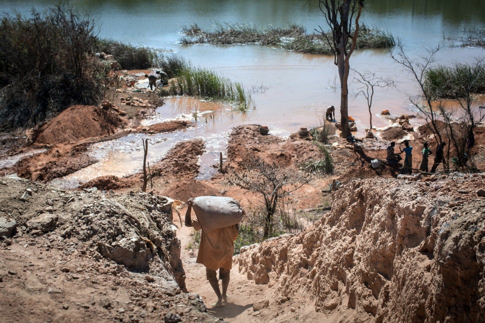 People separate cobalt from sand and rock in a lake in the Democratic Republic of the Congo last year.