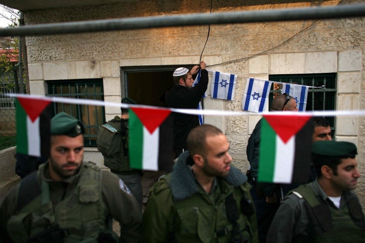 Israeli settlers took over part of el-Kurds' home in 2009. Border police stand outside another home in Sheik Jarrah occupied by Israeli settlers in December that year.