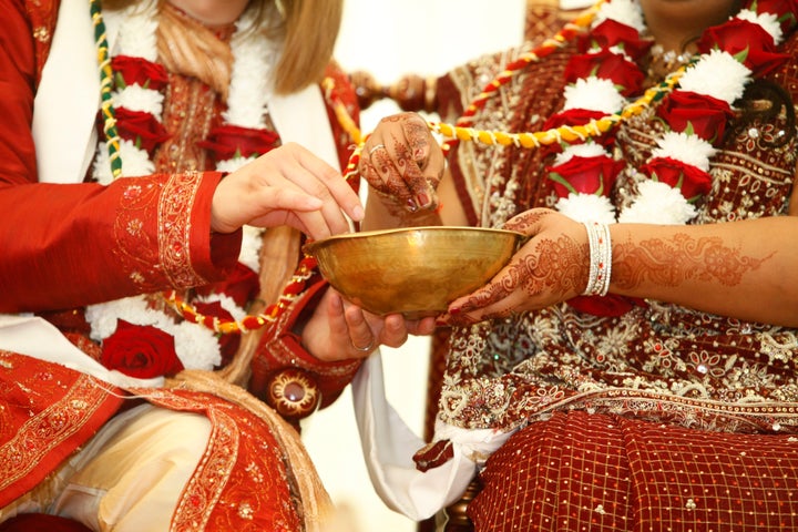 A couple participates in a Hindu wedding ceremony. Interfaith marriages are becoming increasingly common in the United States. 