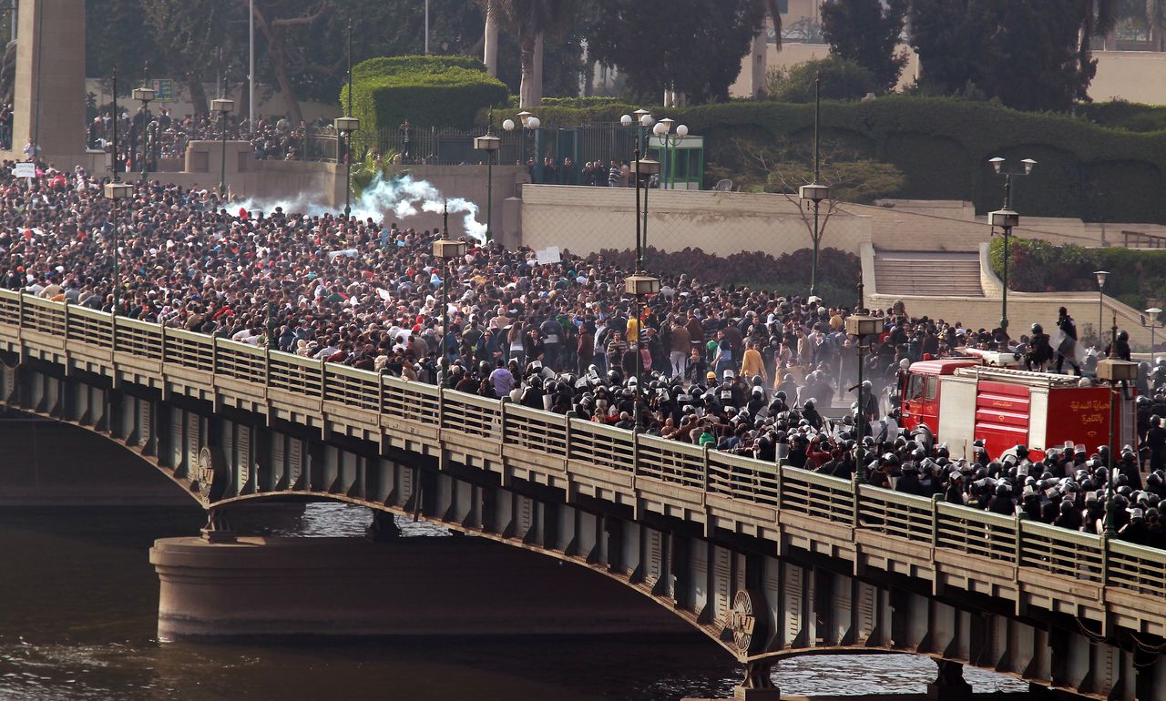 Riot police and protesters clash on the Qasr al-Nir bridge, on Jan. 28, 2011. Fahmy witnessed the police give way to the overwhelming number of demonstrators marching to Tahrir Square.