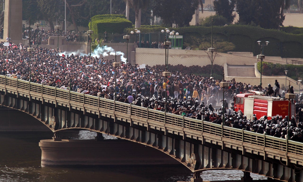 Riot police and protesters clash on the Qasr al-Nir bridge, on Jan. 28, 2011. Fahmy witnessed the police give way to the overwhelming number of demonstrators marching to Tahrir Square.