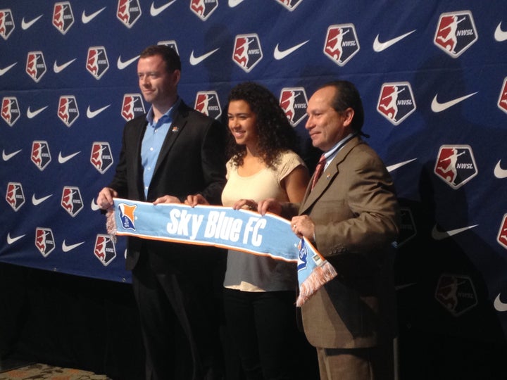 Raquel Rodriguez poses with Sky Blue FC team officials after the team made her the second overall selection in the NWSL draft on Friday, Jan. 15, 2016.