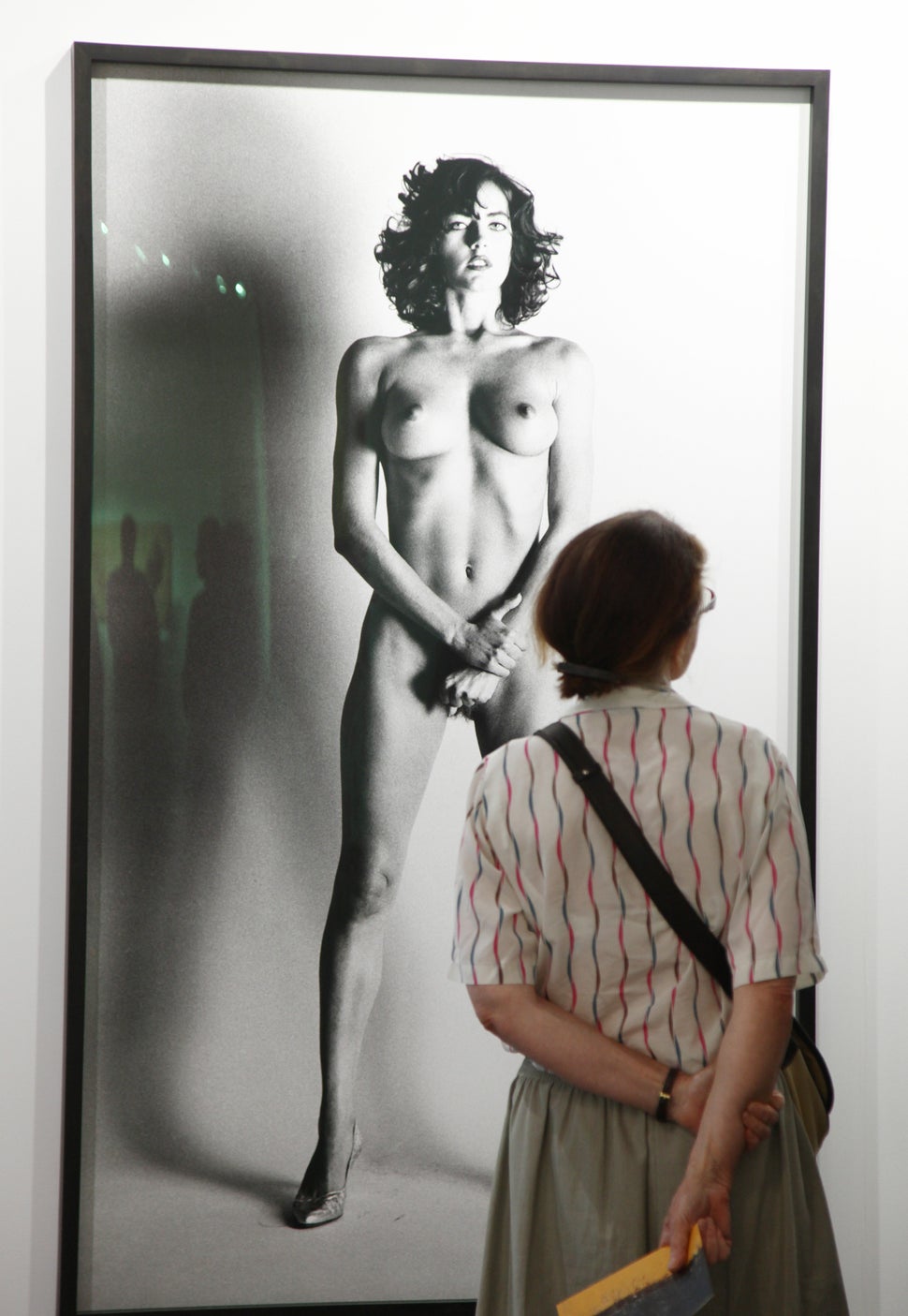 A visitor looks at a photo by Helmut Newton during the VIP opening at Art Basel on June 17, 2015 in Basel, Switzerland.