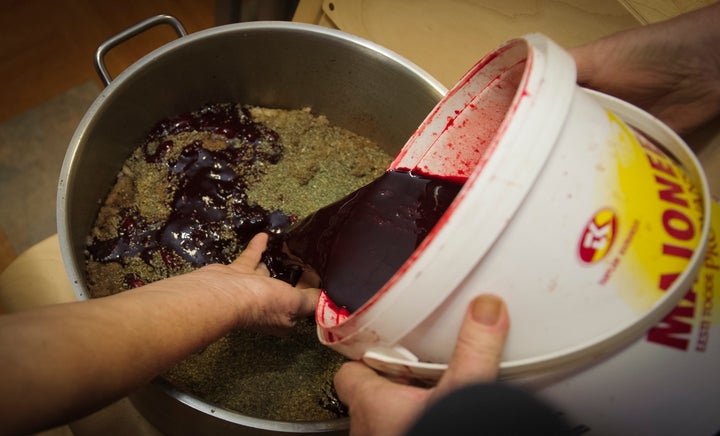 Blood is poured during the preparation of Estonian blood sausage in Tallinn, Estonia, on December 15, 2012.