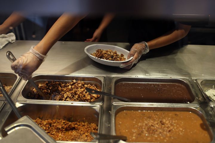 Chipotle restaurant workers fill orders for customers on April 27, 2015, in Miami. The chain has struggled since a series of foodborne illnesses began sickening customers last year.