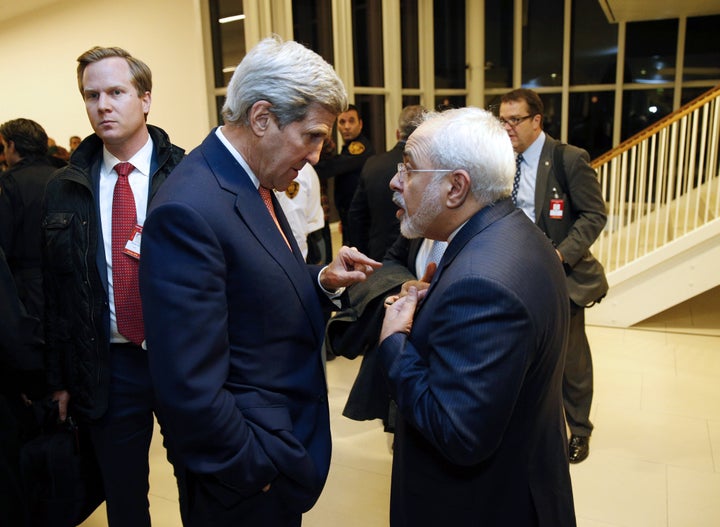 U.S. Secretary of State John Kerry speaks with Iranian Foreign Minister Mohammad Javad Zarif after the IAEA verified that Iran has met all conditions under the nuclear deal during talks in Vienna on January 16, 2016.