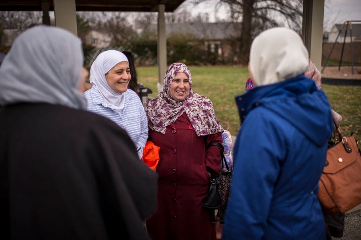 A woman who fled Syria 4 years ago at a potluck at Norfolk Acres Park in Louisville, KY.