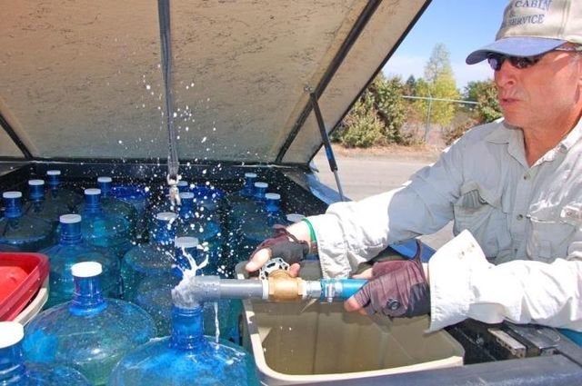 A customer fills five-gallon jugs with recycled water at a fill station operated by Dublin San Ramon Services District, believed to be the first in California to offer such a service.