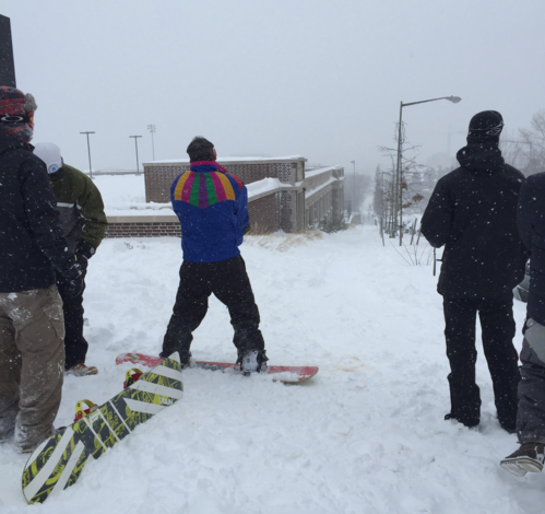 Snowboarders in Washington, D.C. near 13th and Clifton Streets NW.