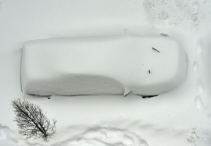A snow covered car is seen from the roof of a building in Washington on Jan. 23, 2016.