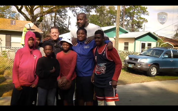 NBA legend Shaquille O'Neal dropped in for a neighborhood basketball game between local children and police officers on Saturday.