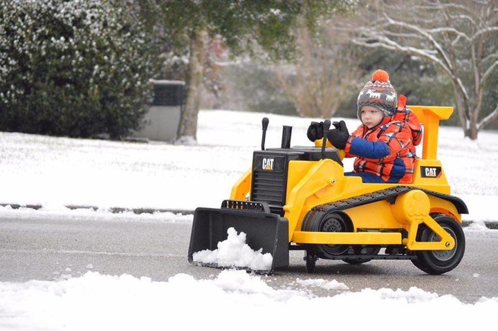 Sam picking up snow in his bulldozer. 