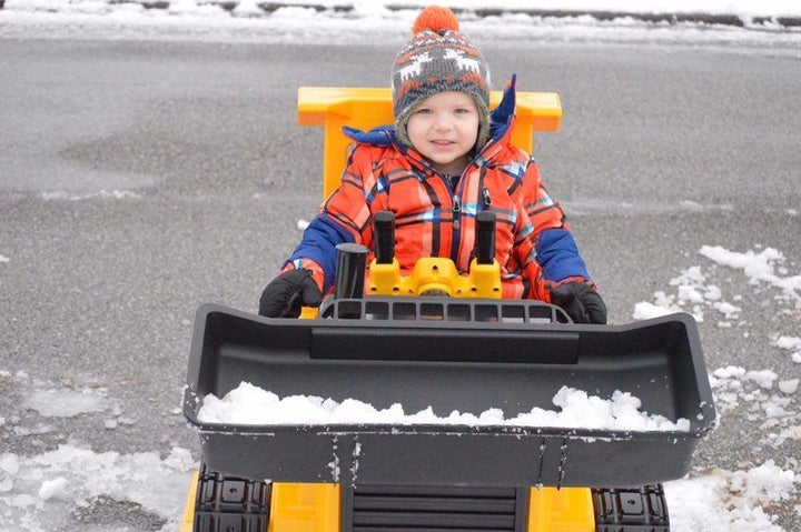 Sam posing for a picture in his toy bulldozer.