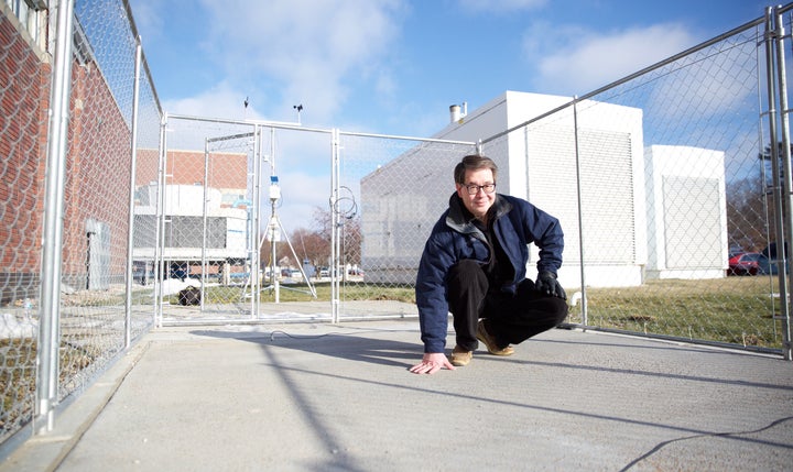 Dr. Chris Tuan stands on a slab of conductive concrete that can carry enough electrical current to melt ice during winter storms.