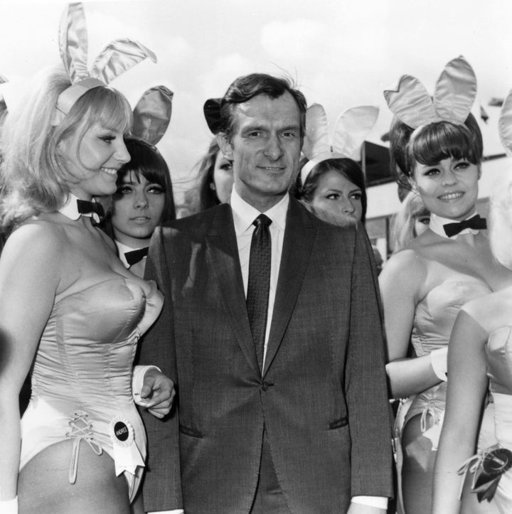 Playboy editor and tycoon Hugh Hefner is greeted by a group of Bunnies from his Playboy Clubs as he arrives in London in 1966.