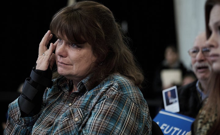 Carrie Aldrich wipes away a tear after speaking with Sanders in Iowa on Monday.