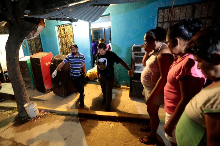 Forensic personnel carry the body of a murdered man in the city of Acapulco. Mexico registered a 7.6 percent increase in the number of homicide victims in 2015.