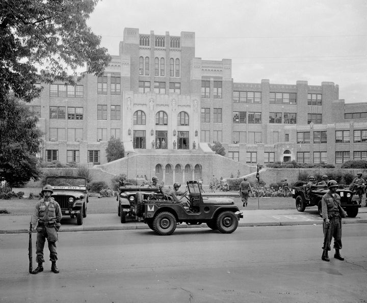 Members of the 101st Airborne Division take up positions outside Central High School in Little Rock, Arkansas, in September 1957. The troopers were on duty to enforce integration at the school.