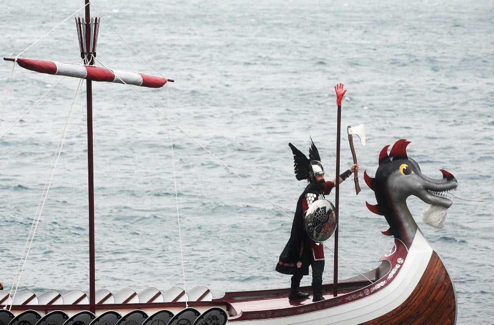 A participant dressed as Vikings stands on the prow of his longboat before the annual Up Helly Aa festival in Lerwick, Shetla