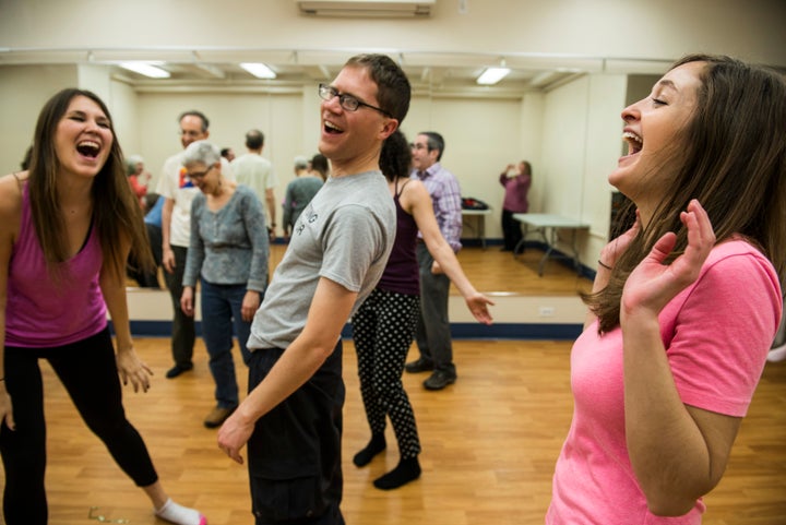 Editors Lindsay Holmes and Sarah Bourassa try laughter yoga at The Laughter Yoga Salon NYC as part of the HuffPost Happiness Challenge.