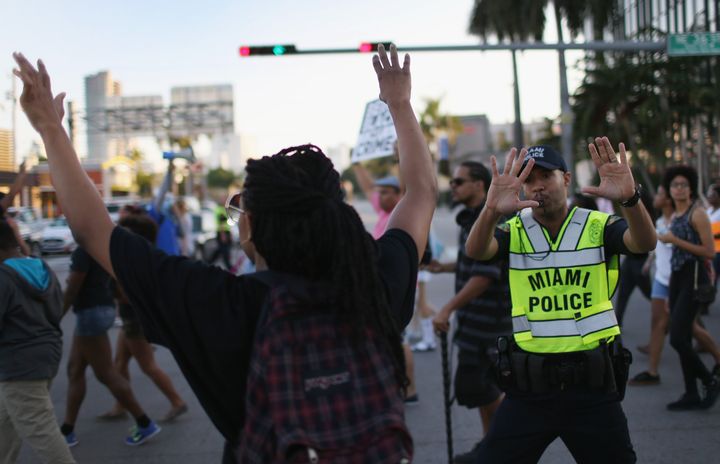 Demonstrators march to protest police abuse in Miami, whose police department is one of those criticized in the ACLU report.