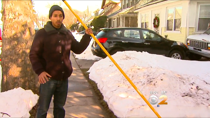 Danny Walls is seen holding a fiberglass pole that he says he used to beat the raccoon to death with.