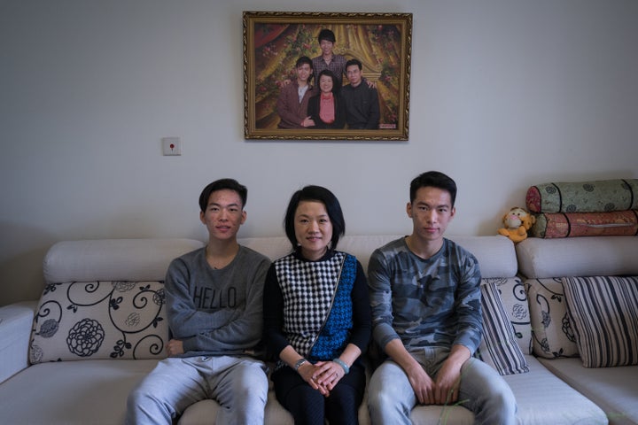 Frank (left) and Richard (right) with their mother Wendy at home in Beijing.