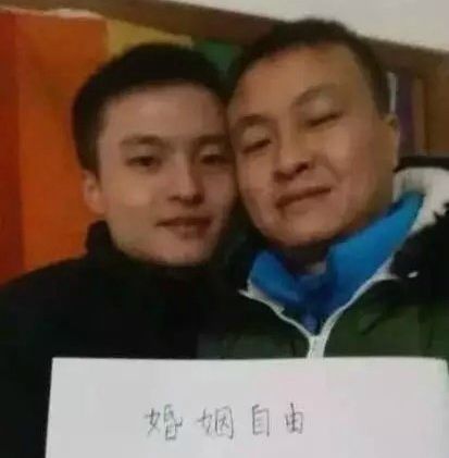 Sun Wenlin, pictured here with his partner Hu Mingliang, holds a piece of paper that reads "Marriage Freedom." Sun sued his local city council after being denied a same-sex marriage certificate. 