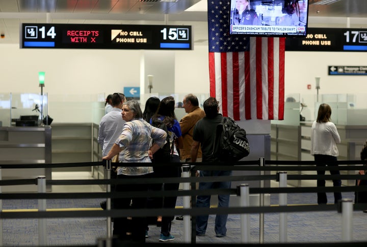 International travelers wait to be interviewed after arriving at Miami International Airport on March 4, 2015. 