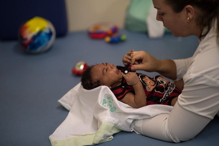 Physical therapist Isana Santana treats Icaro Luis, 2 months, who was born with microcephaly. This photo was taken at Obras Socias irma dulce hospital in Salvador, Brazil on January 28, 2016.