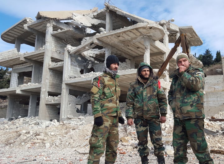 Since the start of the civil war in 2011, over a quarter of a million people have been killed and millions more have been forced to flee their homes. Pro-government forces watch a road in the town of Rabia, Syria, on Jan. 27.