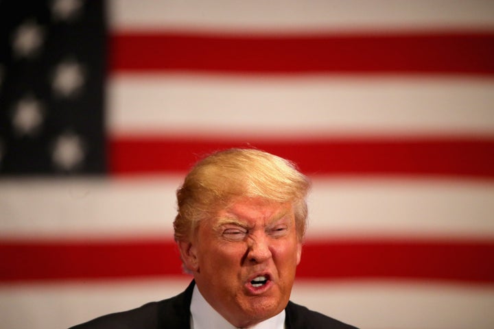 Republican presidential candidate Donald Trump gestures as he speaks to veterans at Drake University on January 28, 2016 in Des Moines, Iowa.