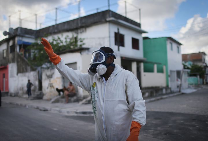 A health worker in Brazil tells residents to remain inside during fumigation in an attempt to eradicate mosquitos, which transmit the Zika virus.