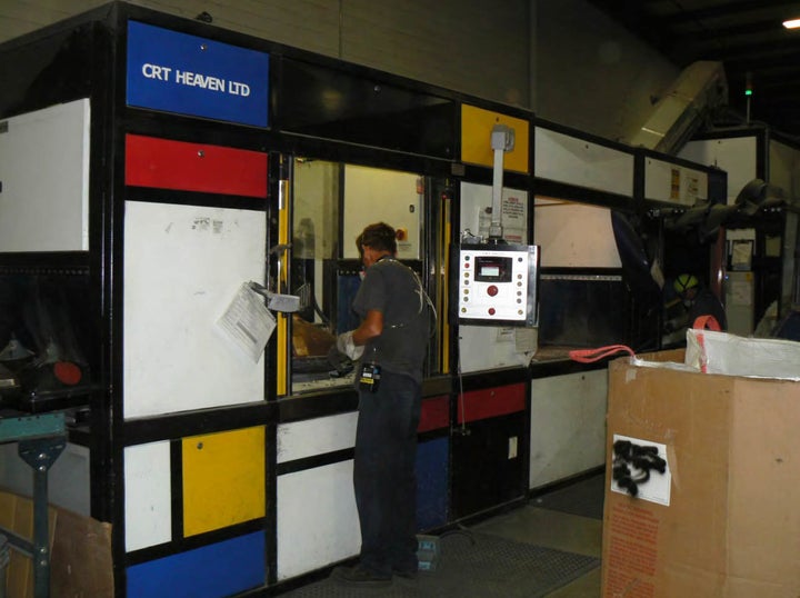 A worker recycles cathode ray tubes using the Angel-Devil machine at the former 2trg facility in Cincinnati.