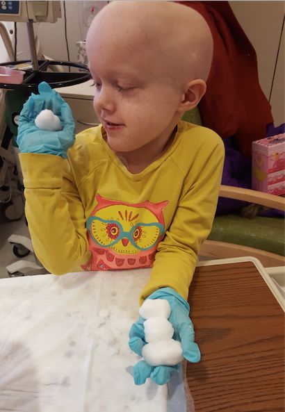 Patient Lucy Wiese playing with snow that Alex Classen brought to the kids. 