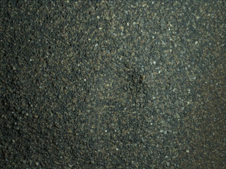 The Curiosity rover used electric lights at night to illuminate this postage-stamp-size view of Martian sand grains.