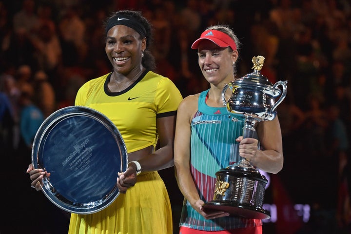 Angelique Kerber of Germany (R) holds the winner's trophy during the awards ceremony following her victory over Serena Williams of the US (L) in their women's singles final match on day 13 of the 2016 Australian Open tennis tournament in Melbourne on January 30, 2016.