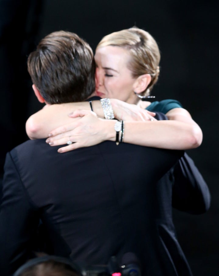 Kate Winslet congratulates Leonardo DiCaprio after he wins his Best Actor award for his role in "The Revenant."