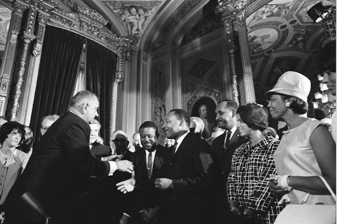 President Lyndon B. Johnson and Dr. Martin Luther King shake hands in the President's Room of the U.S. Capitol on Aug. 6, 1965, the day the Voting Rights Act was signed into law.