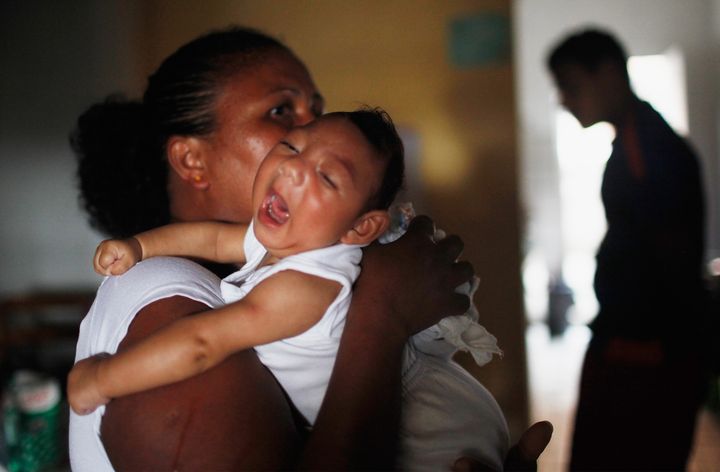 Alice Vitoria Gomes Bezerra, who has microcephaly, is held by her mother on January 31, 2016 in Recife, Brazil.