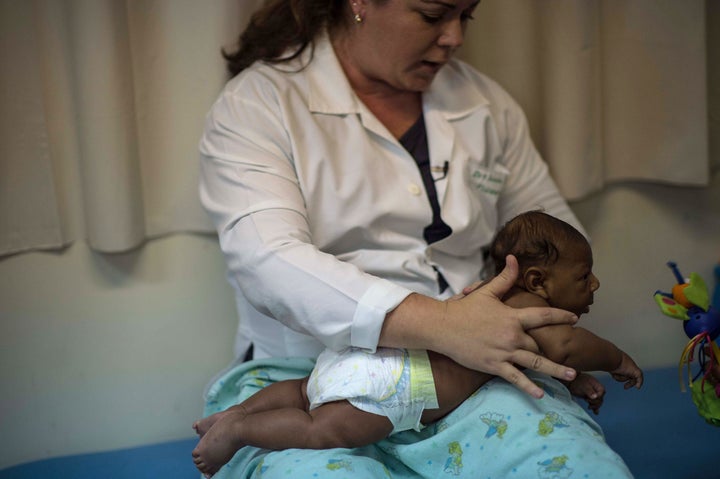 Physical therapist Isana Santana treats Ruan Hentique dos Santos, who has microcephaly.