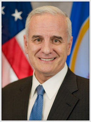 Minnesota Gov. Mark Dayton is spending the night at a hospital after fainting during a political event on Sunday.