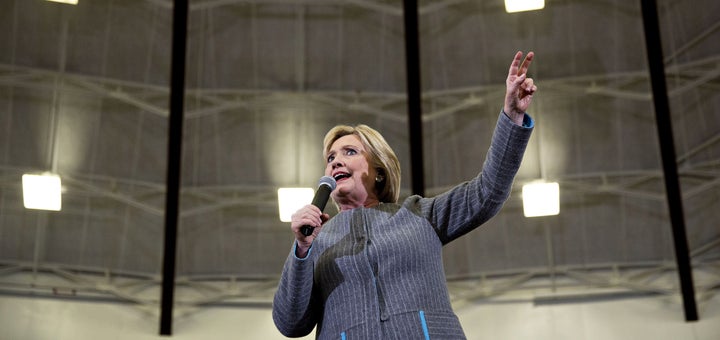 Former Secretary of State Hillary Clinton speaks on Sunday at a campaign event at Abraham Lincoln High School in Des Moines, Iowa. She's projected confidence heading into Monday caucuses.