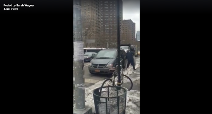 The man is seen putting the pigeons in the back of a nearby minivan.