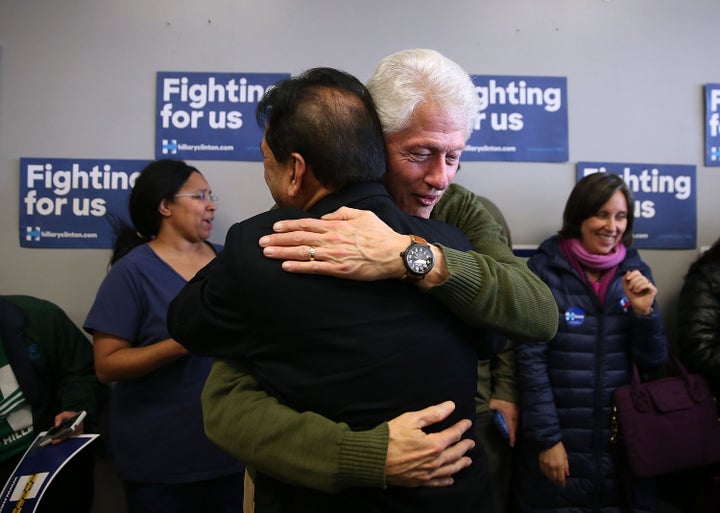 Former U.S. president Bill Clinton hugs a volunteer who is working for his wife, Democratic presidential candidate Hillary Clinton, as he visits a campaign office on her behalf Monday in Ankeny, Iowa.