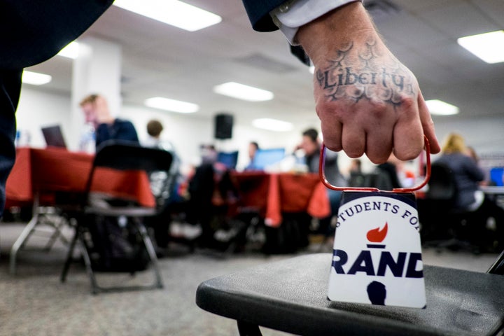 A Rand Paul volunteer rings a cowbell to signify another committed voter for the Republican Kentucky senator at his Des Moines headquarters on Monday.