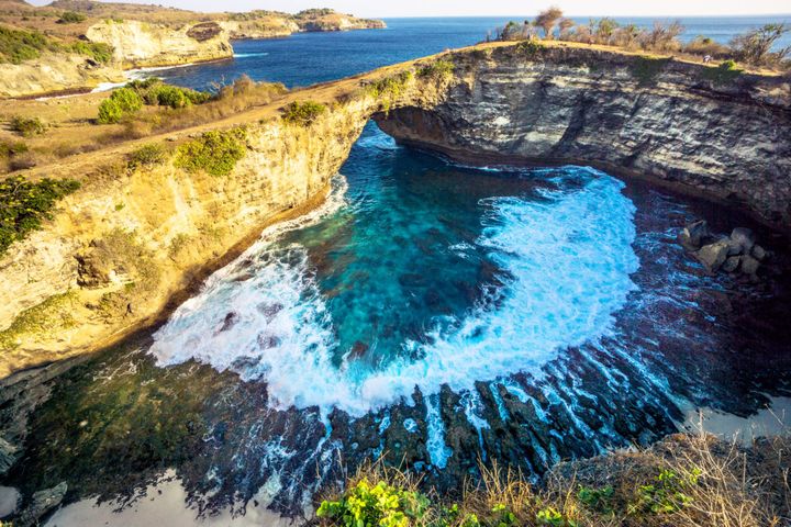 This spot, known as "Broken Beach," is a popular tourist attraction on Nusa Penida.