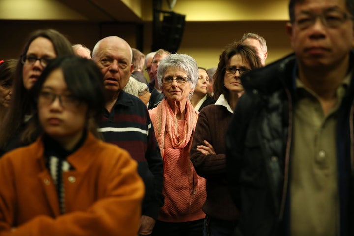 People watch a television showing the Caucus return numbers at the Donald Trump for President Caucus Watch Party at the Sheraton Hotel on Feb. 1, 2016 in Des Moines, Iowa.