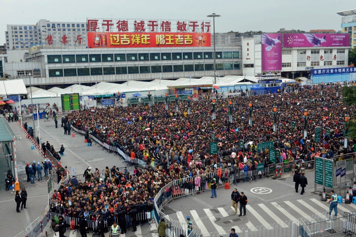 Nearly 100,000 travelers filled the gates outside the railway station in Guangzhou on Feb. 1, one week before the Chinese Lunar New Year.